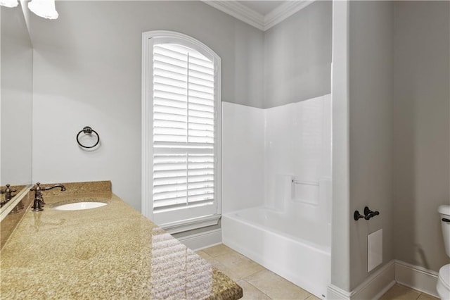 bathroom with crown molding, sink, a healthy amount of sunlight, and toilet