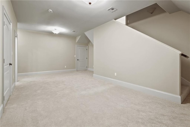 bonus room with light carpet and lofted ceiling