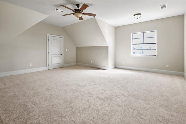 bonus room featuring ceiling fan, light carpet, and lofted ceiling