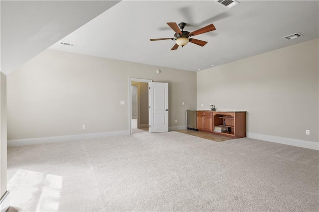 carpeted empty room with ceiling fan and lofted ceiling