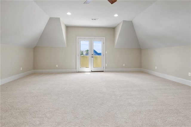 bonus room featuring light carpet, french doors, vaulted ceiling, and ceiling fan