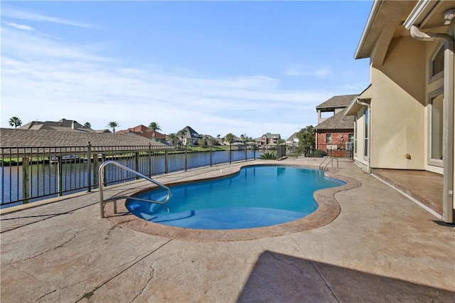 view of pool with a patio area and a water view