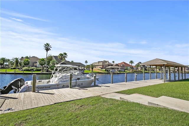 view of dock with a yard and a water view