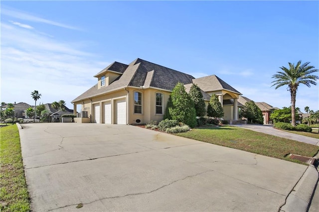 view of front of house with a garage and a front lawn