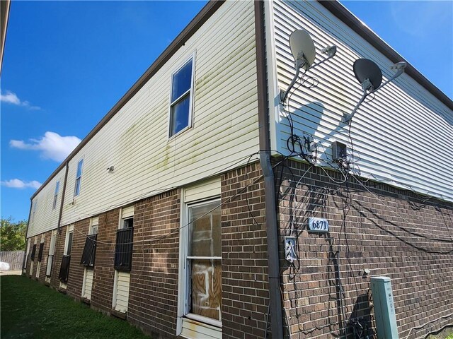 view of side of property with a yard