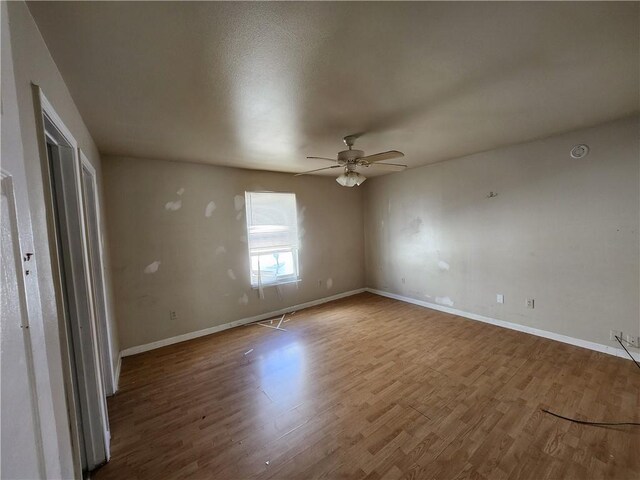 unfurnished bedroom with ceiling fan and hardwood / wood-style floors