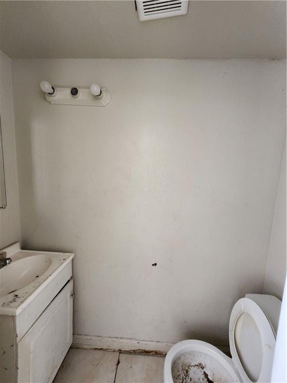bathroom featuring toilet and vanity