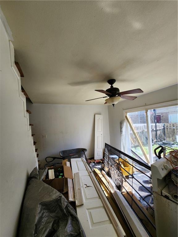 interior space featuring ceiling fan