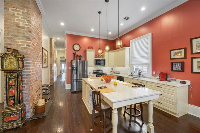 kitchen with a center island, hanging light fixtures, dark hardwood / wood-style floors, black appliances, and ornamental molding