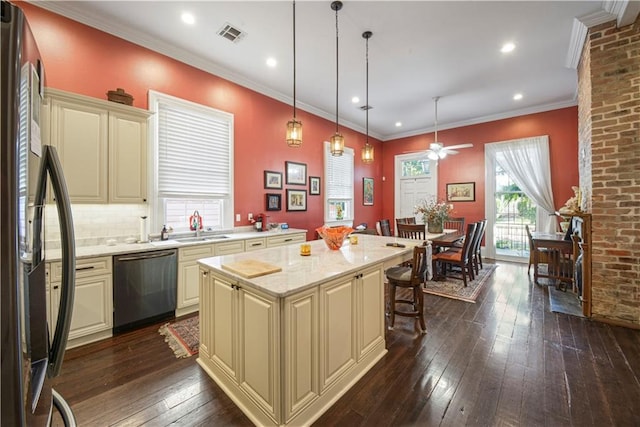 kitchen with a center island, hanging light fixtures, appliances with stainless steel finishes, and dark wood-type flooring