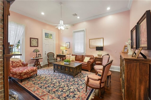 living room with dark hardwood / wood-style flooring, ceiling fan, and crown molding