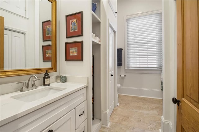 bathroom featuring vanity and toilet