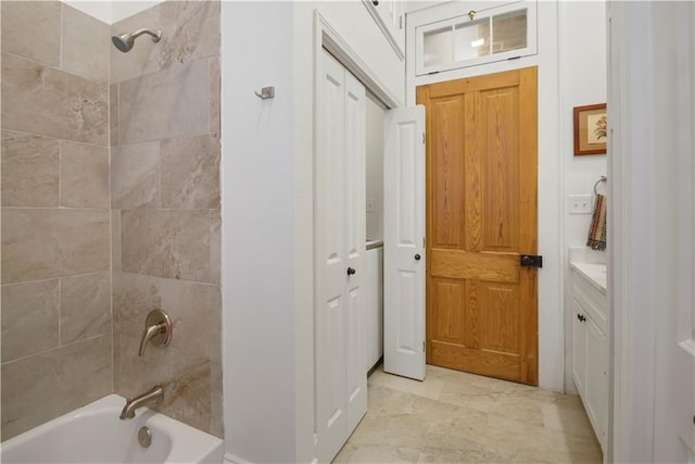 bathroom with vanity and tiled shower / bath