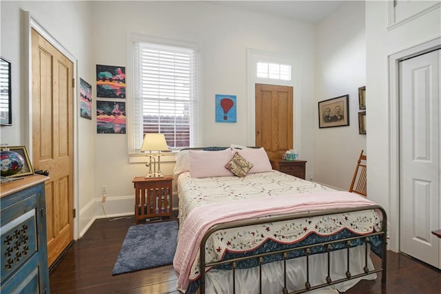 bedroom featuring dark hardwood / wood-style floors and a closet