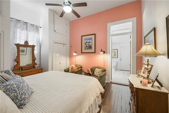 bedroom featuring dark hardwood / wood-style flooring, ensuite bath, a closet, and ceiling fan