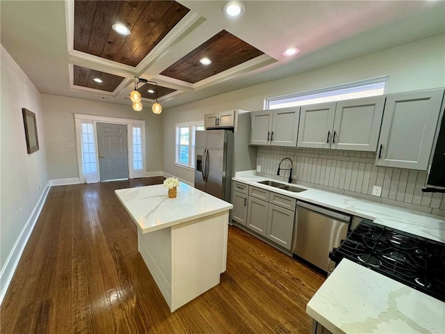 kitchen with a kitchen island, dark hardwood / wood-style flooring, stainless steel appliances, and tasteful backsplash