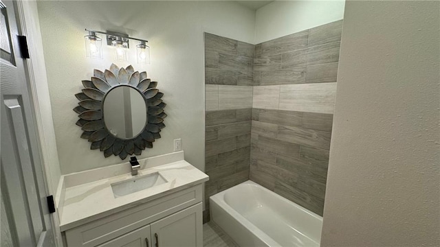 bathroom featuring vanity and tiled shower / bath