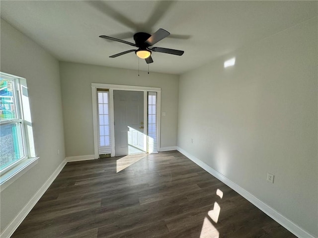 unfurnished room with dark hardwood / wood-style floors and ceiling fan