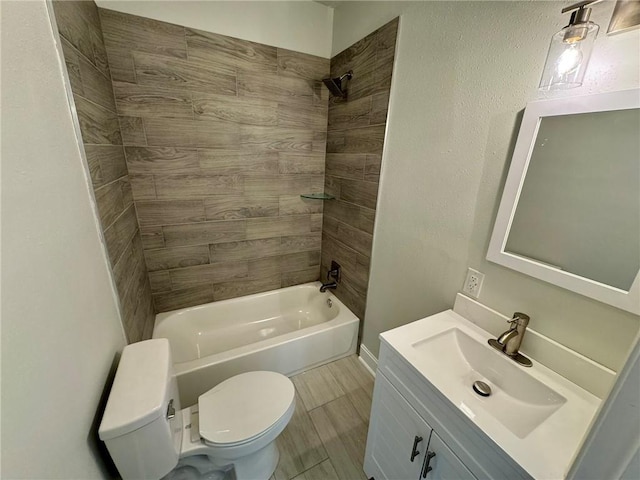 full bathroom with vanity, tiled shower / bath combo, and toilet