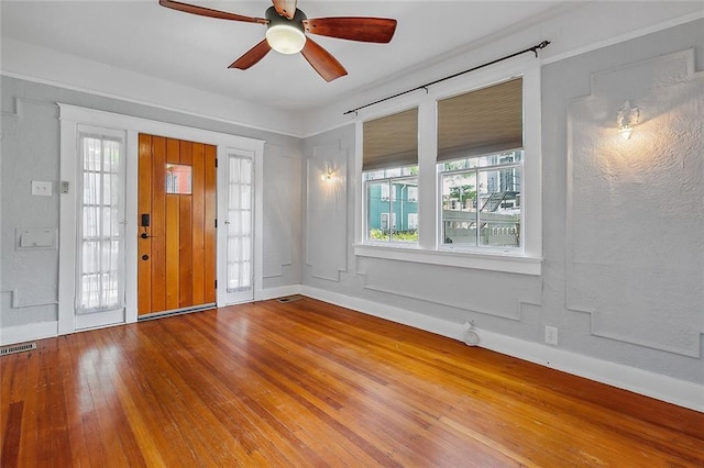 foyer entrance featuring wood-type flooring and ceiling fan