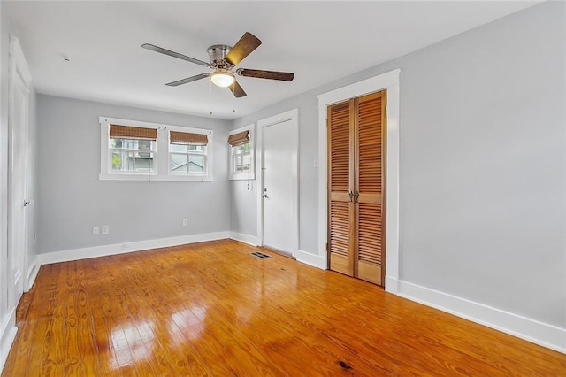 unfurnished bedroom with ceiling fan and hardwood / wood-style flooring