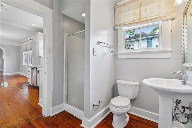 bathroom with toilet, hardwood / wood-style floors, plenty of natural light, and a shower with door