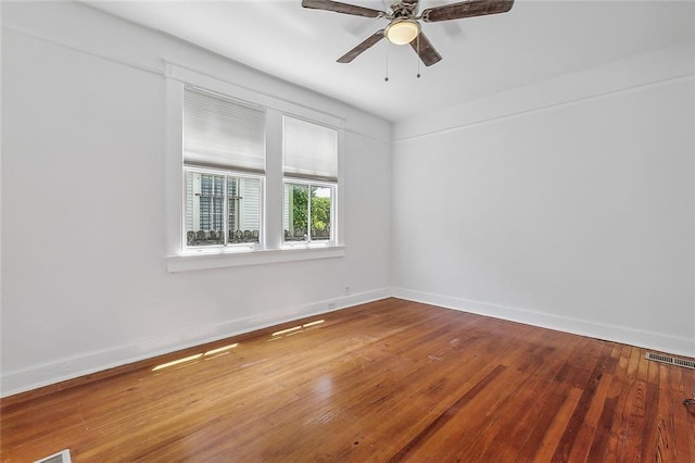 unfurnished room with hardwood / wood-style floors and ceiling fan