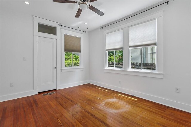 spare room featuring hardwood / wood-style flooring and ceiling fan