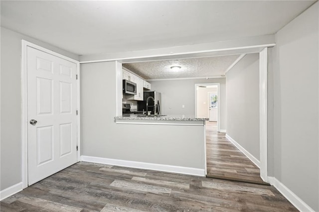 kitchen with dark wood-type flooring, white cabinets, stainless steel appliances, and sink