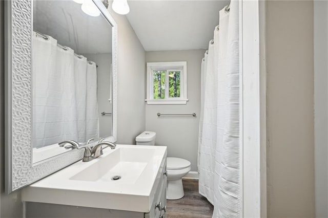 bathroom featuring hardwood / wood-style floors, vanity, and toilet