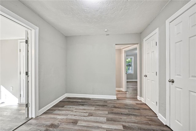 interior space with wood-type flooring and a textured ceiling