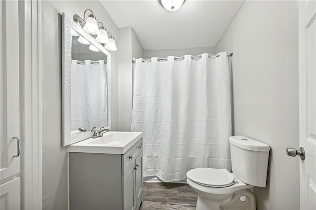 bathroom featuring vanity, curtained shower, toilet, and wood-type flooring