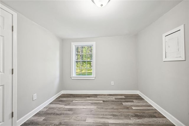 spare room with dark wood-type flooring