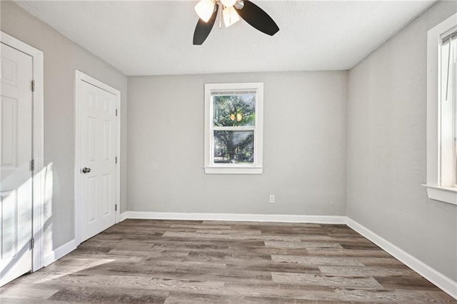 empty room with wood-type flooring and ceiling fan