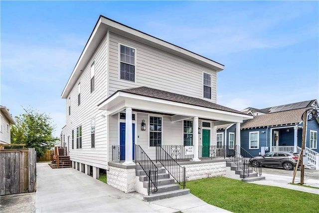 view of front of property with a porch and a front lawn