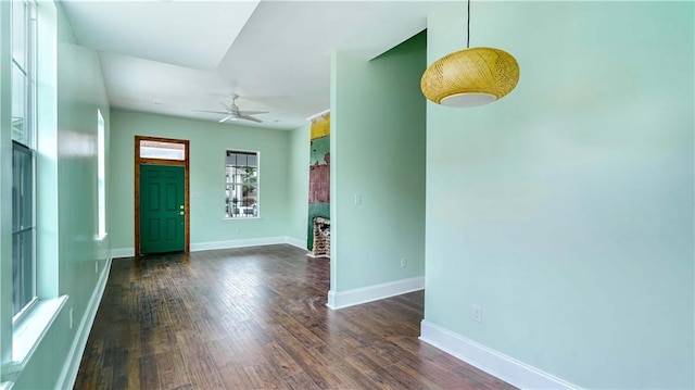 foyer entrance with ceiling fan and dark hardwood / wood-style flooring