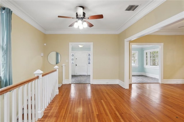 entryway with ceiling fan, ornamental molding, and light hardwood / wood-style flooring