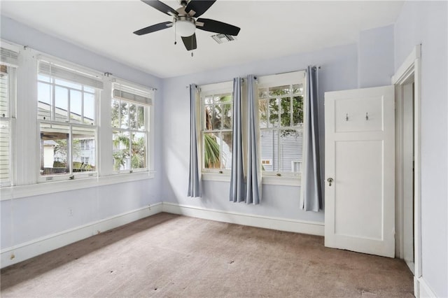 carpeted spare room with ceiling fan