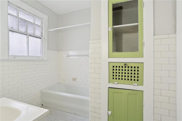 bathroom with tile patterned floors and tile walls