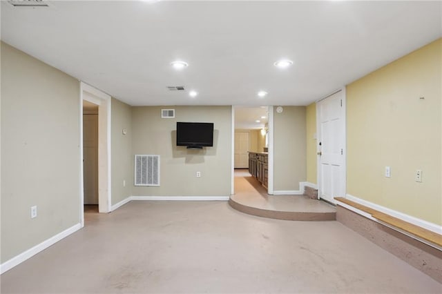 unfurnished living room with concrete flooring