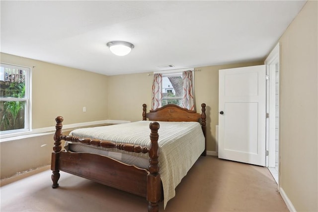 bedroom featuring concrete floors