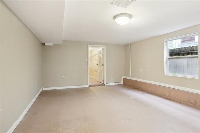 unfurnished room with concrete flooring