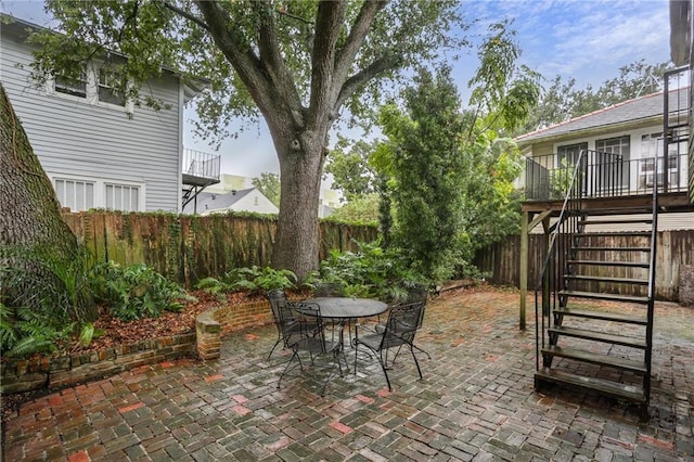 2808 Octavia St, New Orleans, LA 70115 - fenced backyard featuring a patio, stairs, and outdoor dining space