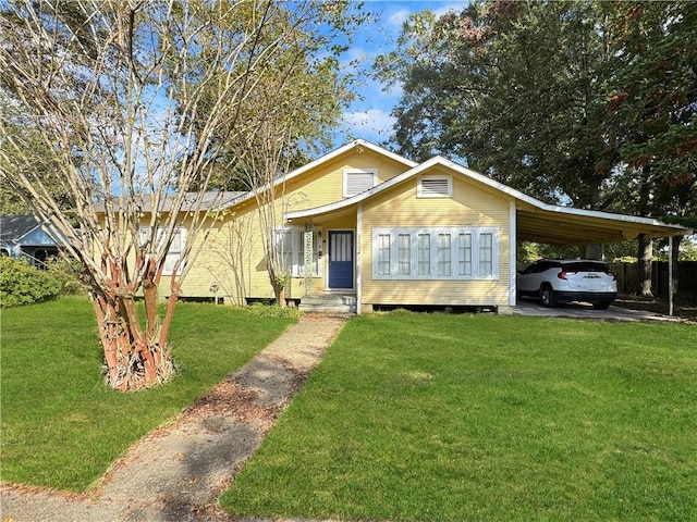 view of front of property with a carport and a front yard