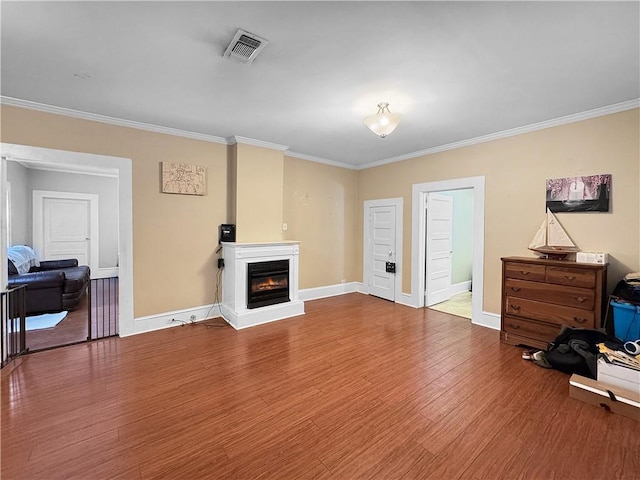 living room with hardwood / wood-style floors and crown molding