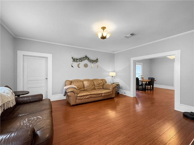 living room with hardwood / wood-style flooring and crown molding