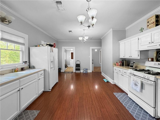 kitchen featuring dark hardwood / wood-style floors, a chandelier, decorative light fixtures, white appliances, and white cabinets