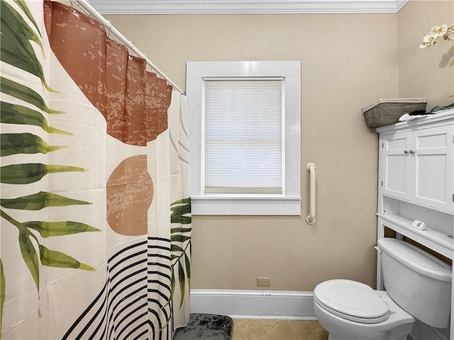 bathroom featuring tile patterned floors, toilet, and ornamental molding