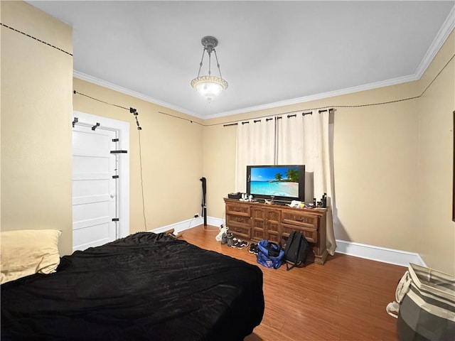 bedroom with crown molding and hardwood / wood-style floors