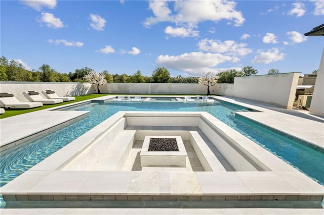 view of swimming pool with a patio area, an in ground hot tub, and an outdoor fire pit